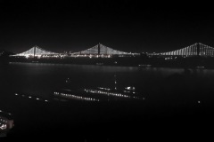 The Bay Bridge sparkles at night.